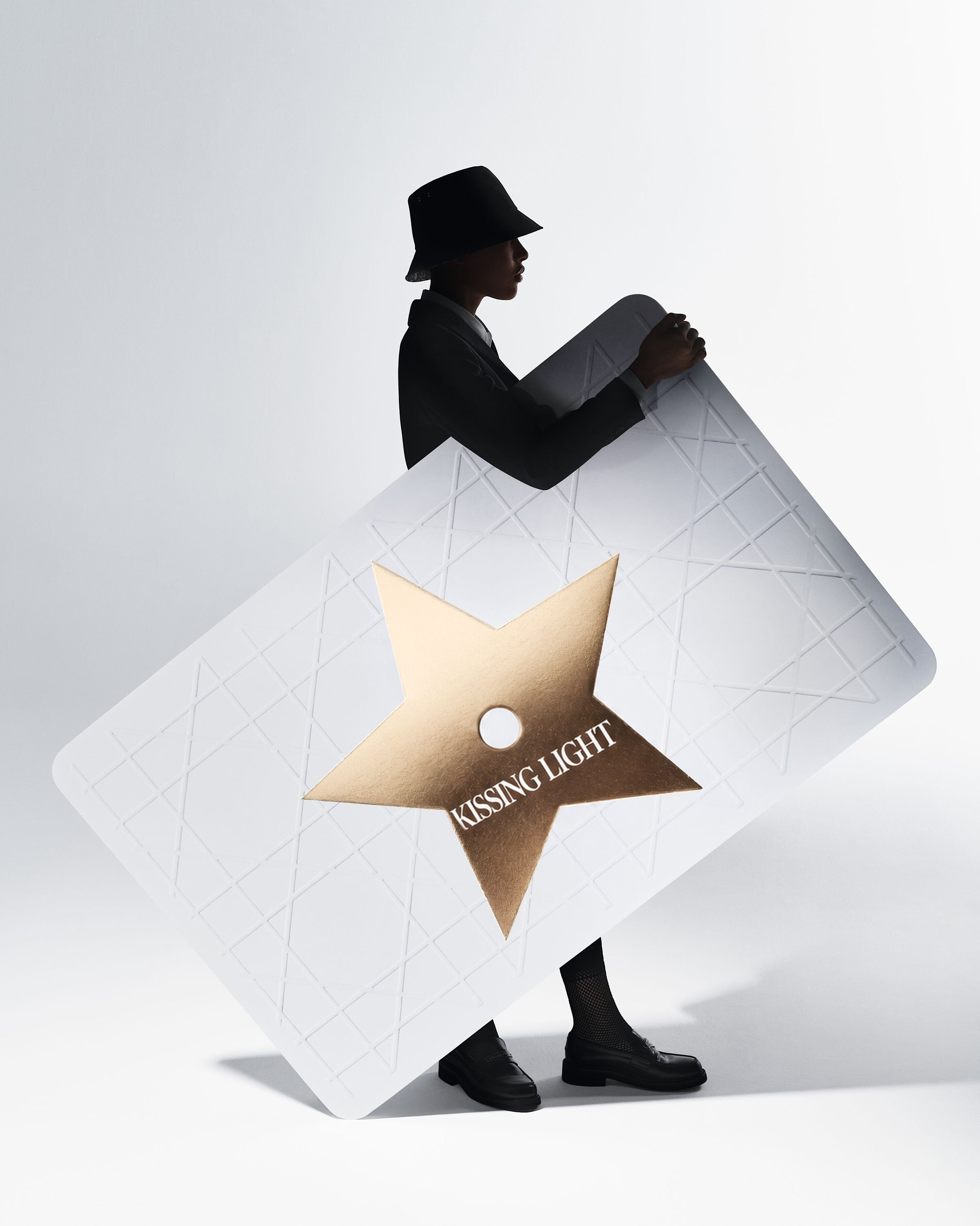 Kissing Light gift card presented as an oversized couture object